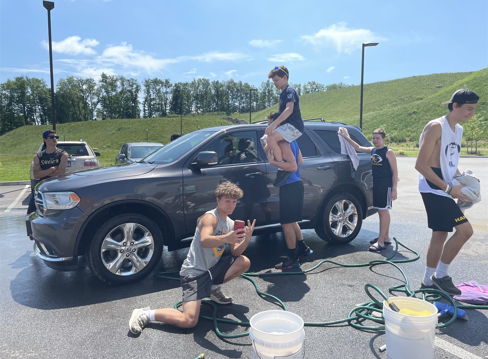 Players washing a car at the 2021 car wash