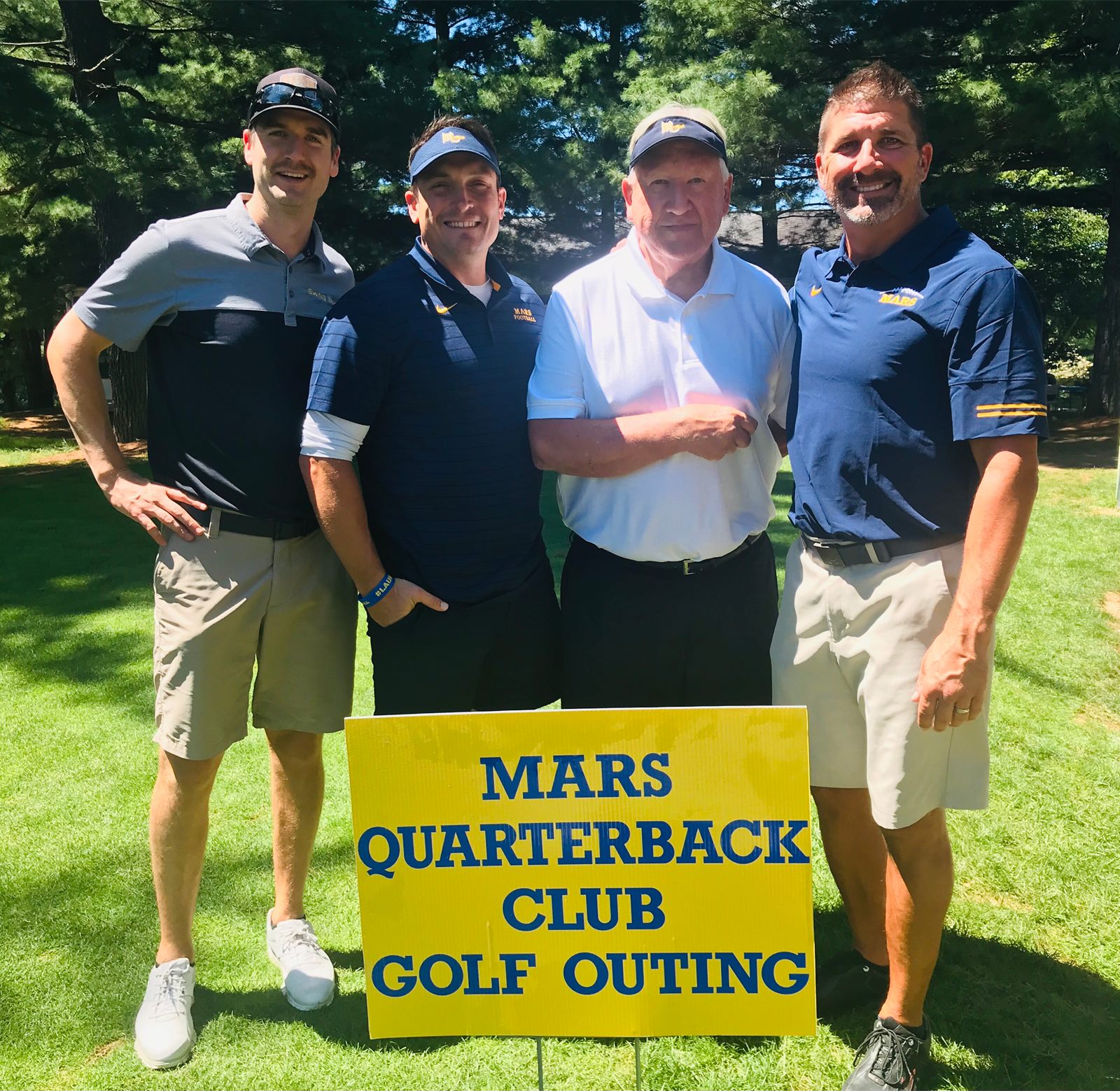 Golfers with the Mars Quarterback Club Golf Outing sign
