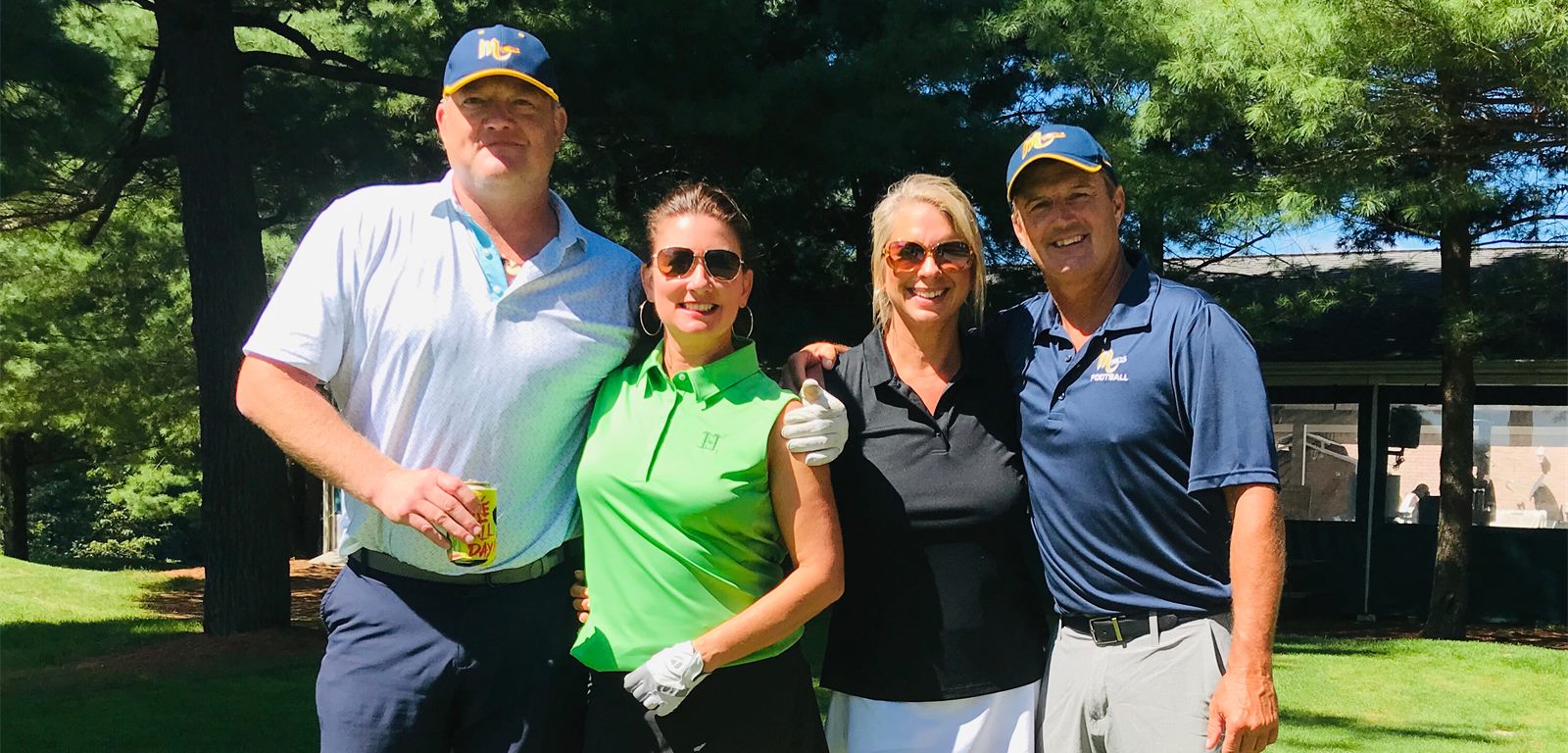 Golfers posing with the Mars Quarterback Club Golf Outing sign