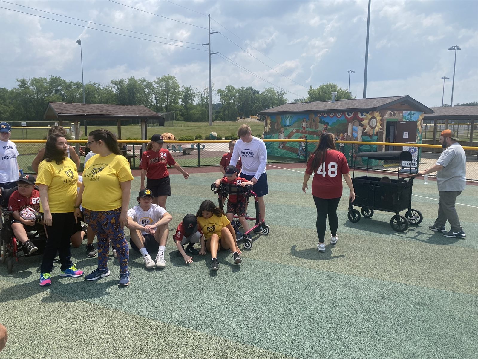 Mars football players with Miracle League athletes