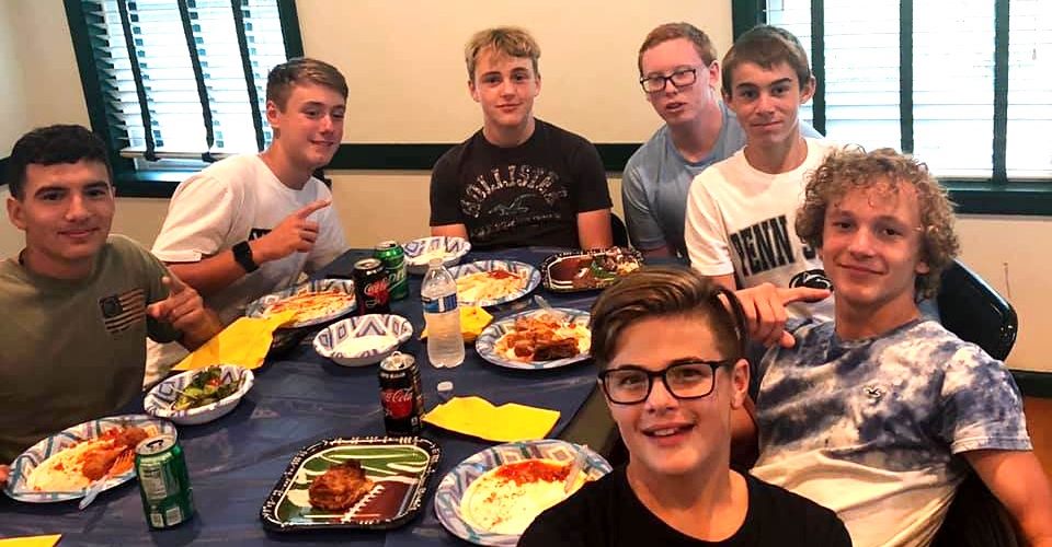 Players at a team spaghetti dinner