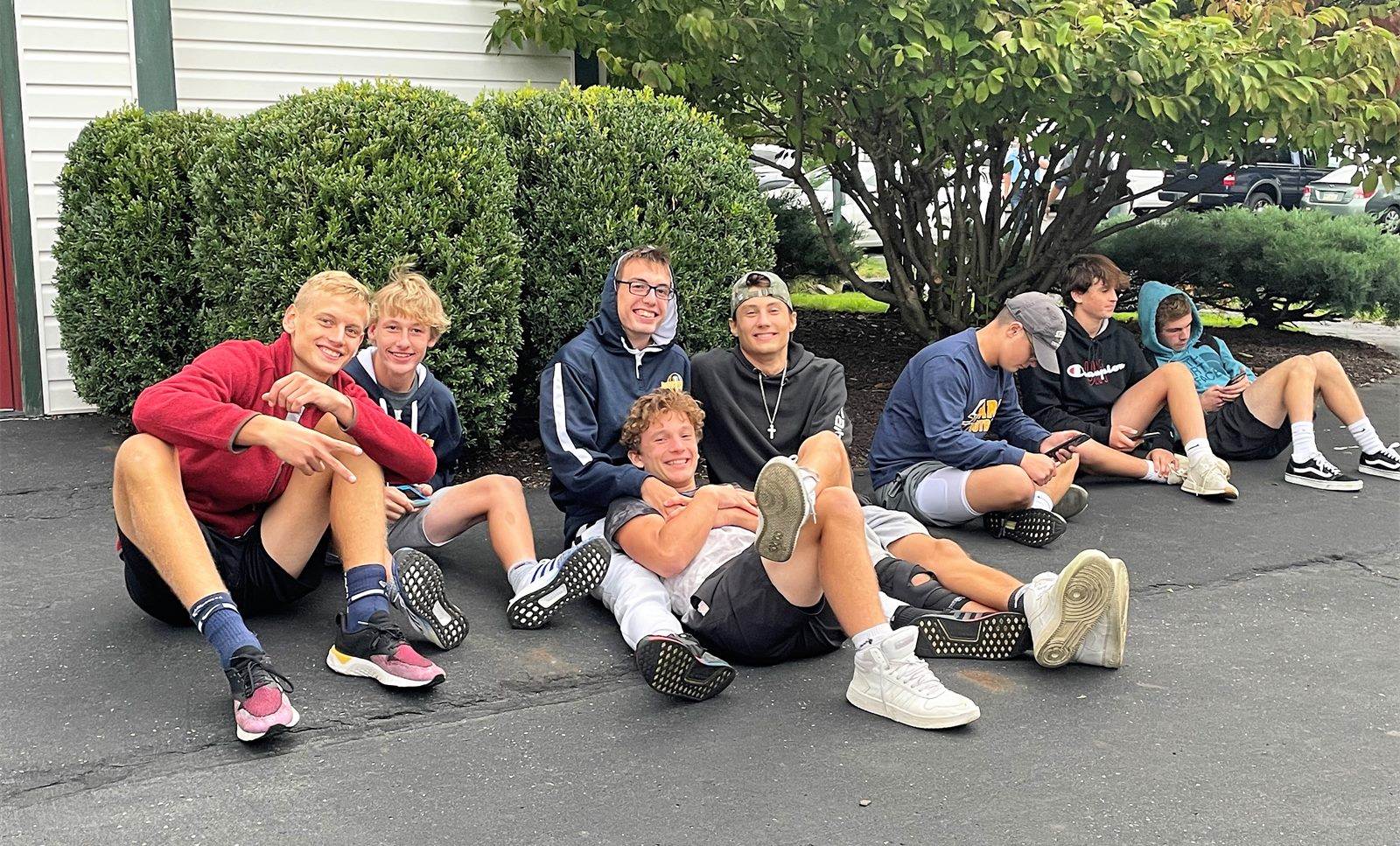 Players relaxing outside at a team spaghetti dinner