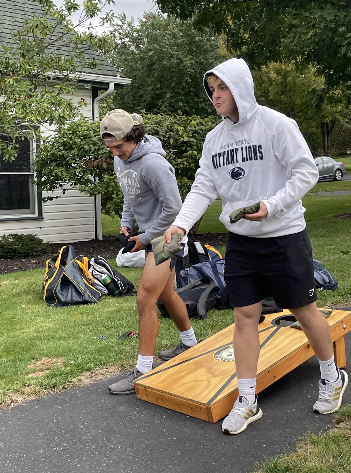 Players playing cornhole at a team spaghetti dinner