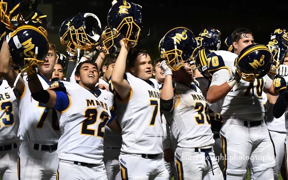 Mars Planets players celebrating with their helmets raised